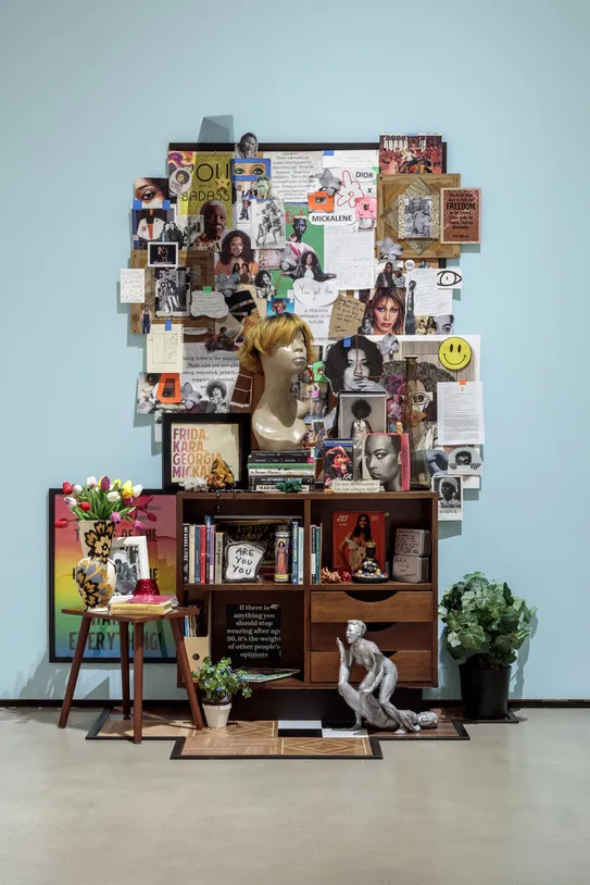 Photo of the Mickalene Thomas's altar featuring miscellaneous objects books and photos
