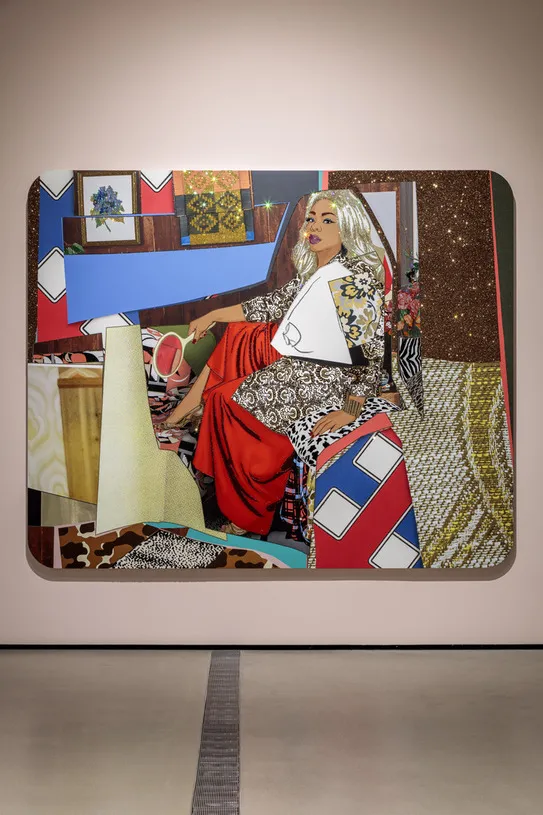 Photo of Mickalene Thomas painting featuring a black women with blonde hair sitting down holding a handheld mirror against a collaged background